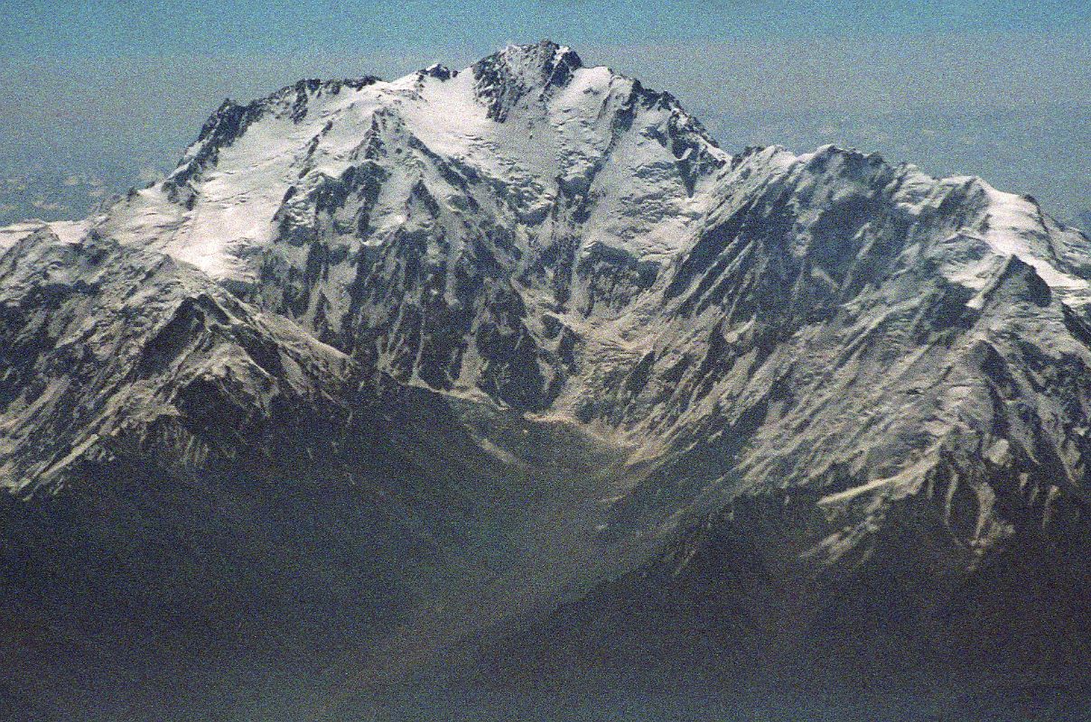 06 Nanga Parbat Diamir Face And Mazeno Ridge On Flight From Islamabad To Skardu Iqbal motioned me to an area where there are only two seats with room for two people to sit on the floor. There it is, within arms reach. Nanga Parbat in perfect early morning splendor! We are passing by the Diamir Face, as I click photo after photo. The massive Mazeno Ridge runs down to the right of Nanga Parbat. The Mazeno ridge is the longest ridge on any 8000m mountain and includes eight 7000m peaks. Nobody has managed to traverse the ridge and continue to the summit of Nanga Parbat.